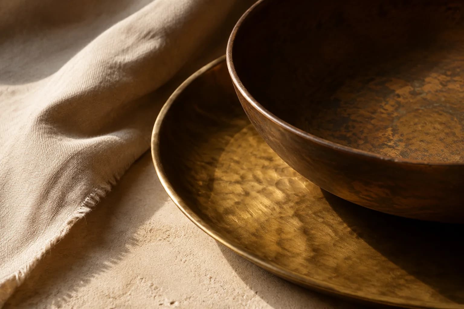 A still life exploring warm brass and deep bronze surfaces in natural light